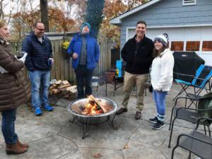 People standing around a fire pit